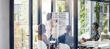 Employees in the meeting room of the office