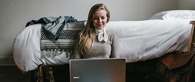 A woman looking at the direction of the computer