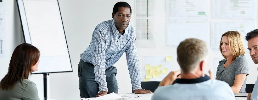 Man with DNA of a CFO running a team meeting