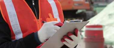 A construction worker writing on a notepad