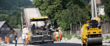 Construction vehicles and machinery paving out concrete