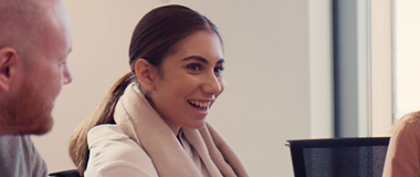 Employees laughing in a group meeting