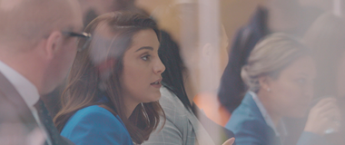Employees in a meeting room planning business objectives
