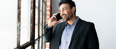 Man in suite talking on phone 