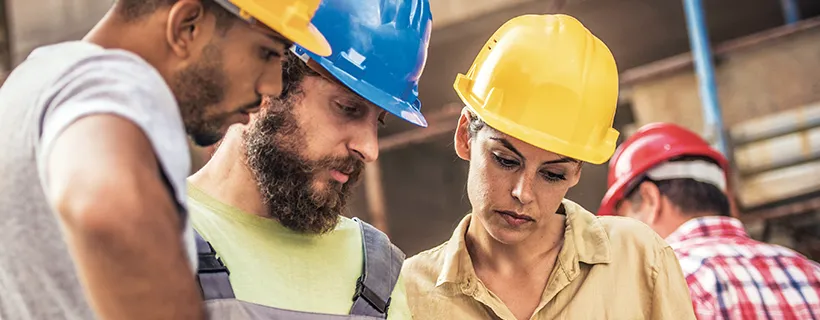 Two men and a woman on the road to construction manager